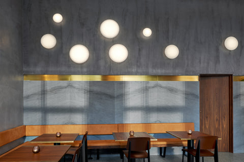 aj eklipta wall lamp designed by arne jacobsen for louis poulsen in a restaurant 