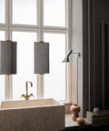 stainless steel polished aj wall lamp by louis poulsen in bathroom