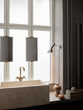 stainless steel polished aj wall lamp by louis poulsen in bathroom