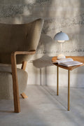 &Tradition Pinwheel HM7 End Table in oak and brass paired with Wulff lounge chair and Flowerpot VP9 lamp