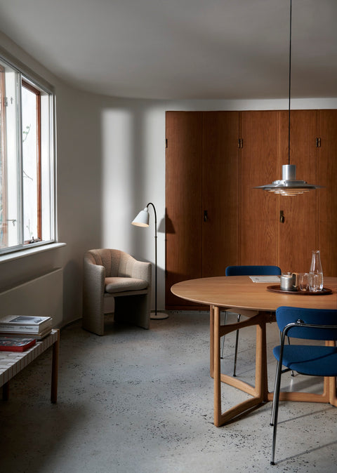 Drop Leaf HM6 dining table by &Tradition styled in modern living room with blue chairs and pendant lamp