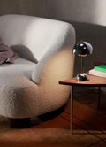 Close-up of &Tradition Pinwheel HM7 End Table next to Margas LC3 sofa and Flowerpot VP9 lamp