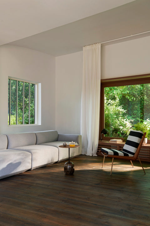 Scandinavian interior featuring the Boomerang HM1 Chair by &Tradition, designed by Hvidt & Mølgaard, paired with a minimalist grey sofa