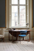 Drop Leaf HM6 table in walnut by &Tradition used as desk in Scandinavian interior with blue chair