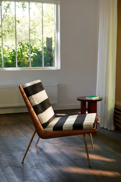 Boomerang HM1 Lounge Chair by &Tradition, designed by Hvidt & Mølgaard, with bold striped upholstery in a sunlit living room