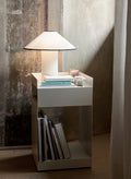 Rotate SC73 in ivory by &Tradition styled as a bedside table with lamp and books