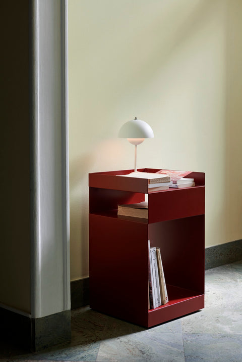 Rotate SC73 in merlot red by &Tradition beside doorway with brass lamp and chair