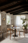 Scandinavian dining room with Betty TK1 Side Chairs in oak and marble-top table by &Tradition