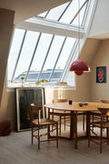 Drop Leaf HM6 dining table in oak by &Tradition with Wegner chairs under skylight and red pendant