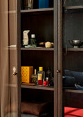 Close-up of Trace SC88 Cabinet by &Tradition in Dark Stained Oak showcasing interior shelving and brass hardware