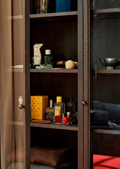 Close-up of Trace SC88 Cabinet by &Tradition in Dark Stained Oak showcasing interior shelving and brass hardware