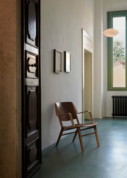 AX HM11 Lounge Chair by &Tradition styled in minimalist hallway with Scandinavian pendant lighting