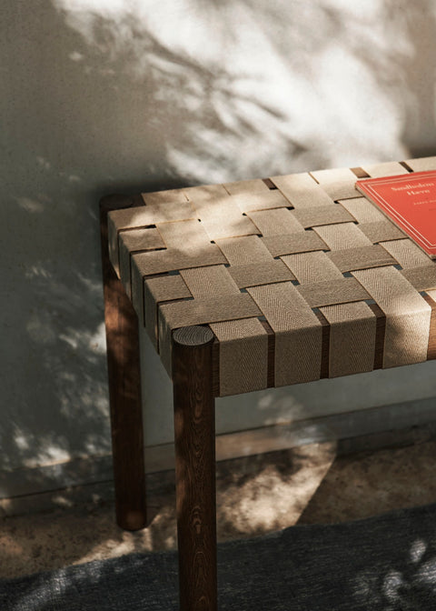 Close-up of Betty TK4 Bench seat detail showing hand-woven linen webbing on smoked oak frame