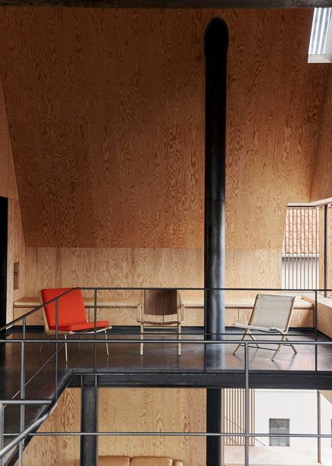 Mid-century modern setup with the Boomerang HM1 Chair by &Tradition, designed by Hvidt & Mølgaard, in vibrant red upholstery