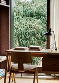 Daystak RD3 Desk and Daystak Side Chair RD1 by &Tradition in beech finish, styled by a window with the Tripod HM9 table lamp and books.