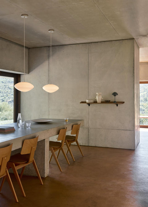 Daystak RD1 Side Chairs by &Tradition in beech set along a long dining table in Scandinavian interior