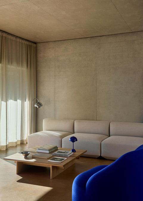 &Tradition Flowerpot VP12 Floor Lamp in chrome beside wooden shelving with the Daystak Side Chair and Momento accessories.