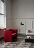 Tripod HM8 Floor Lamp by &Tradition in black, styled with bold red armchair and neutral sofa in Scandinavian interior