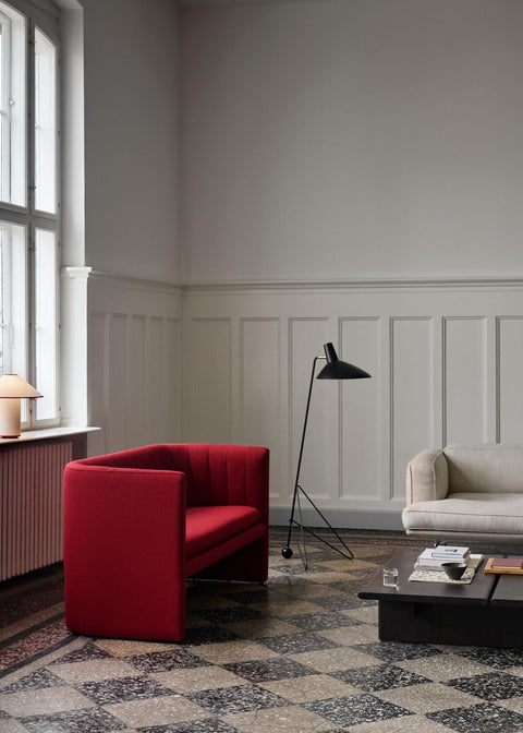 Tripod HM8 Floor Lamp by &Tradition in black, styled with bold red armchair and neutral sofa in Scandinavian interior