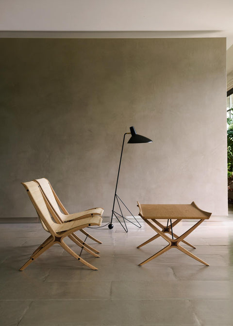 Tripod HM8 Floor Lamp by &Tradition styled with folding wooden lounge chairs and side table in modern interior setting