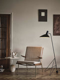 Tripod HM8 Floor Lamp by &Tradition with mid-century lounge chair and side table in warm, minimal Scandinavian setting
