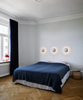 ph hat wall lamp designed by poul henningsen for louis poulsen in a bedroom