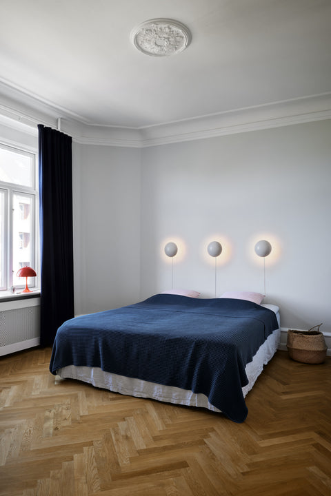 ph hat wall lamp designed by poul henningsen for louis poulsen in a bedroom