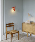 danish modern interior with electric orange aj wall lamp by louis poulsen