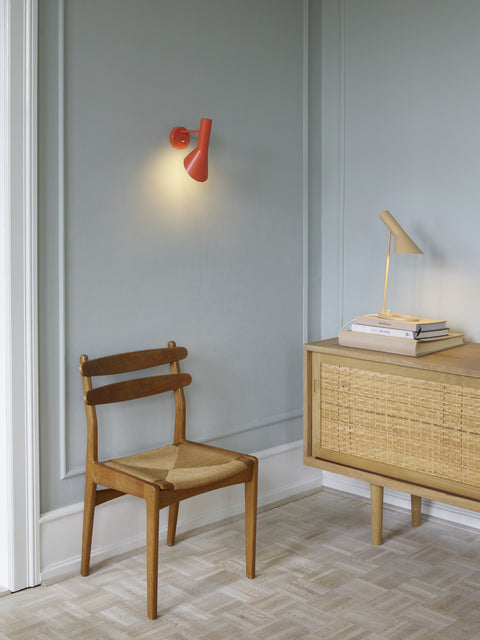 danish modern interior with electric orange aj wall lamp by louis poulsen