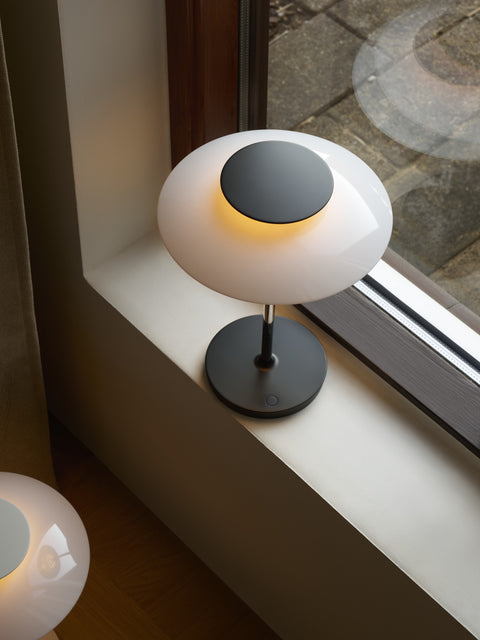 Close-up of PH 80 Portable Lamp in chrome finish showcasing multi-shade design by Louis Poulsen