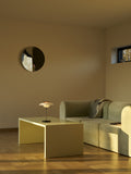 PH 80 Portable Lamp in chrome softly glowing on a coffee table in a modern living room interior