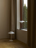 PH 80 Portable Lamps in white and chrome displayed together in a Scandinavian-inspired living room
