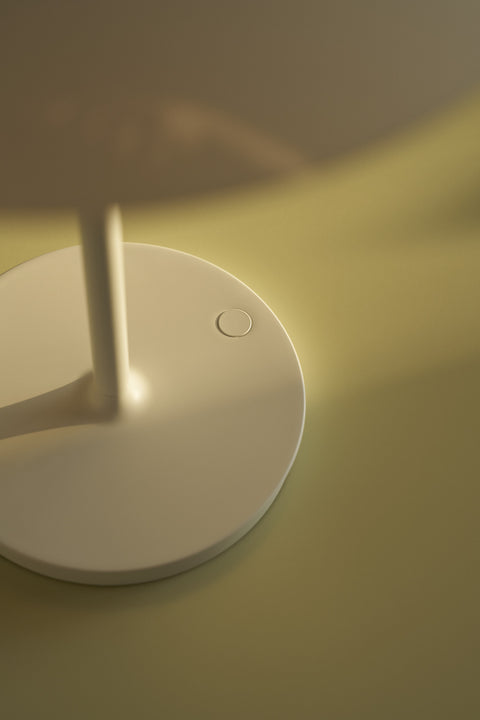 Detail view of PH 80 Portable Lamp in white finish showing circular touch control on base under soft light