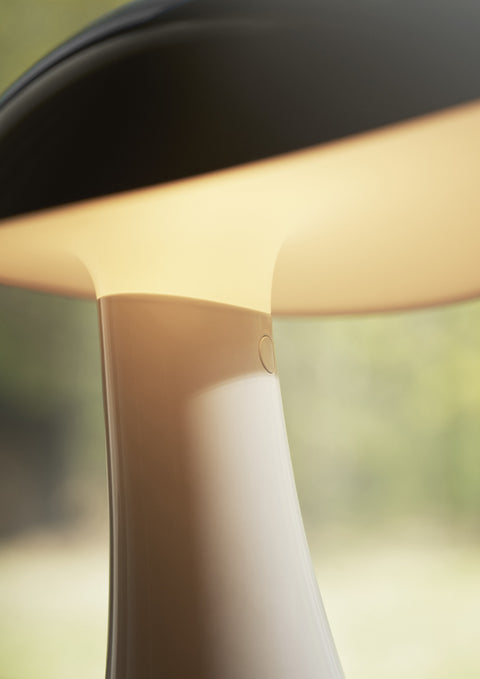 Close-up view of the Rumee 220 Portable Lamp’s illuminated shade highlighting its smooth finish and seamless design.