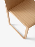 Detail of Allwood AV35 Dining Chair by &Tradition showing smooth oak grain and elegant seat profile