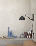 Elegant Muuto Ambit Wall Lamp adding modern charm to minimalist bedroom decor