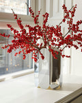 HAY Arcs Vase, Large, Mirror, mirror finish steel vase, close up of the vase holding red berry branches on a bright white windowsill