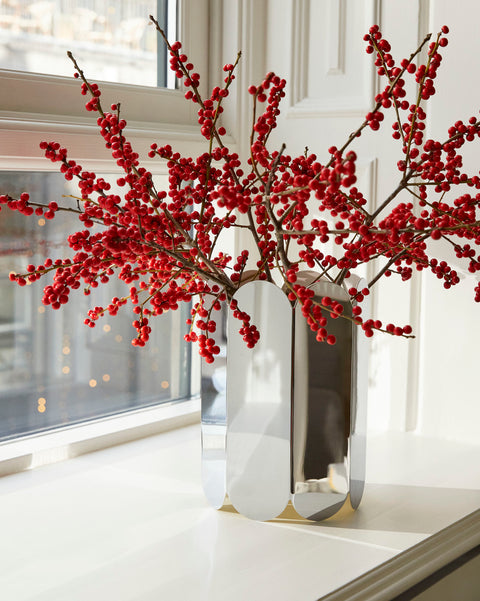 HAY Arcs Vase, Large, Mirror, mirror finish steel vase, close up of the vase holding red berry branches on a bright white windowsill