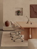 Audo Copenhagen Co Task Chair, Fully Upholstered, Without Arms, Co Task Chairs sit at an Androgyne Dining Table in a calm, beige room, styled with an Interconnect Candle Holder
