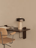 Audo Copenhagen Co Task Chair in light oak at a dark wood Corbel Desk with a Reverse Table Lamp, an open book and a glass of water