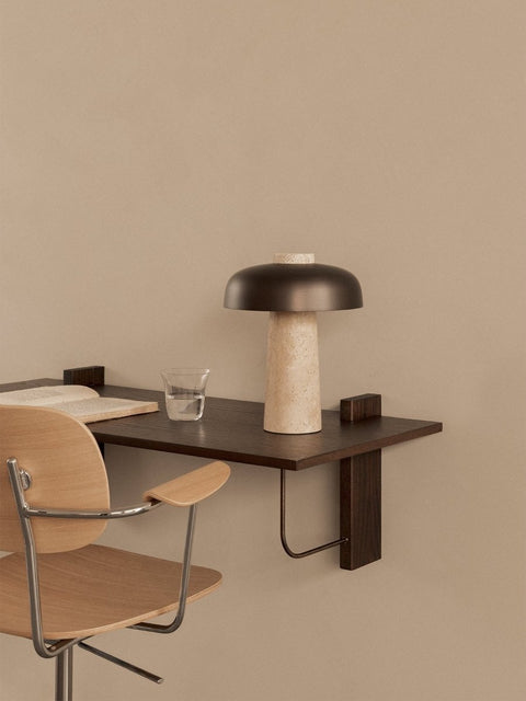 Audo Copenhagen Co Task Chair in light oak at a dark wood Corbel Desk with a Reverse Table Lamp, an open book and a glass of water