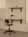 Audo Copenhagen Co Task Chair, Non-Upholstered, Co Task Chair at a dark wood Corbel Desk with a Reverse Table Lamp. A Corbel Shelf holds books and a Sentiment Paperweight