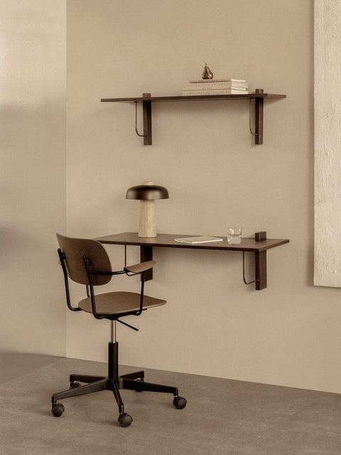 Audo Copenhagen Co Task Chair, Non-Upholstered, Co Task Chair at a dark wood Corbel Desk with a Reverse Table Lamp. A Corbel Shelf holds books and a Sentiment Paperweight