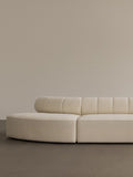 Audo Copenhagen Eave Seamline Modular Sofa, Rounded Modules, 34" Depth, close-up of the Eave Seamline Modular Sofa in cream bouclé, with its curved form and detailed backrest stitching