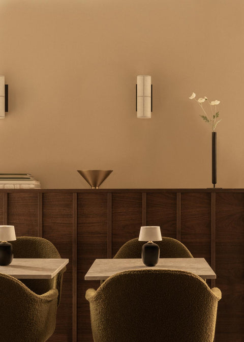 torso table lamp portable in a restaurant designed by Kroeyer-Saetter-Lassen for audo copenhagen