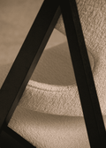 Close-up detail of Knitting Lounge Chair showing the textured upholstery and angular black oak frame.