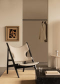 Upholstered Knitting Chair in neutral tones with black oak frame, styled in a Scandinavian interior setting.