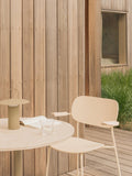 Audo Copenhagen Co Dining Chair, Outdoor, ivory Co Dining Chair, Outdoor, Nook Dining Table, olive Ray Table Lamp Portable, notebook and water glass on a wooden patio