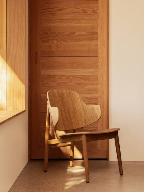 Audo Copenhagen The Penguin Wooden Lounge Chair in a styled interior