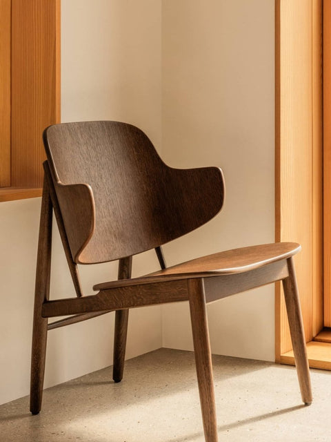 Audo Copenhagen The Penguin Wooden Lounge Chair in a styled interior